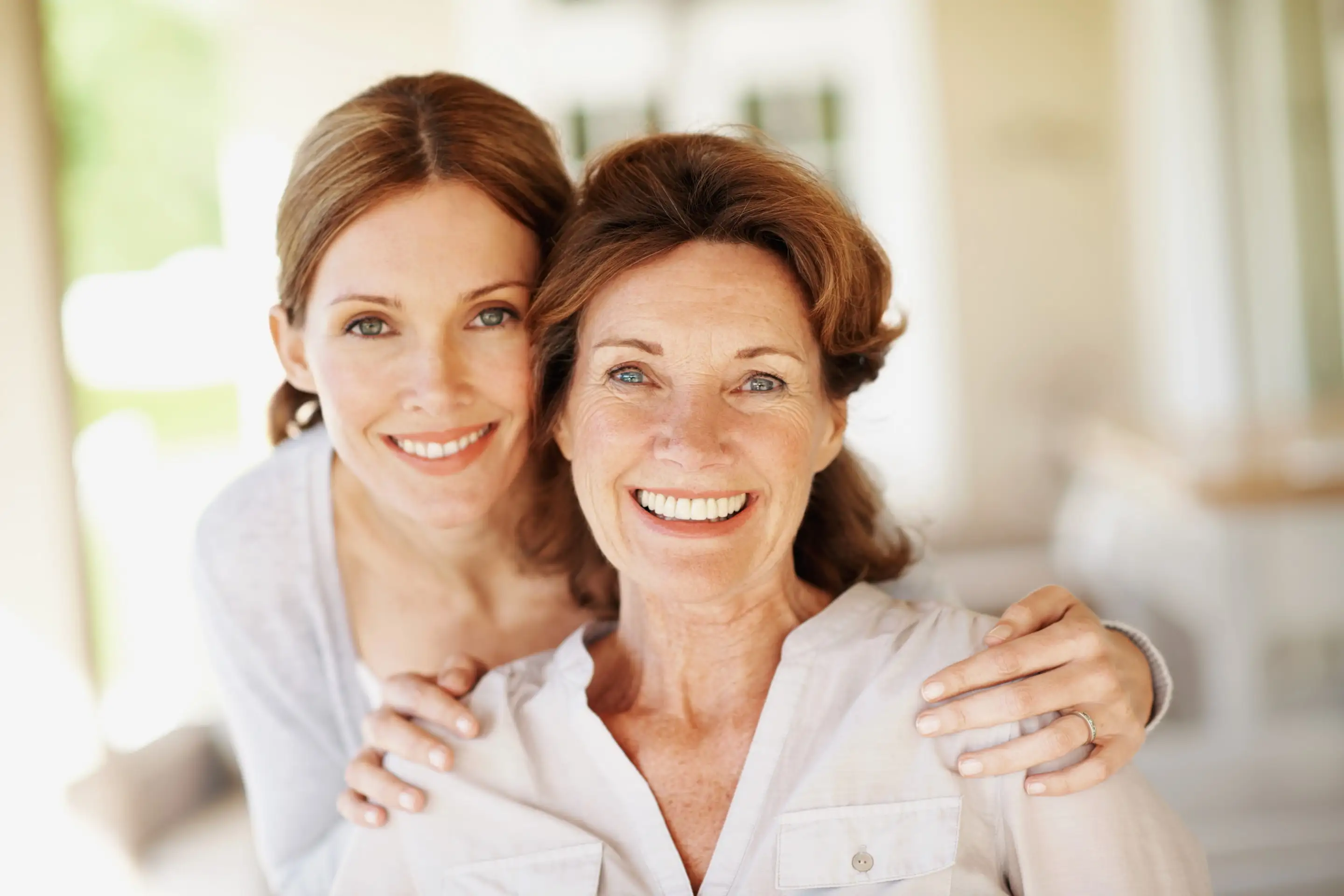 Two women embracing and smiling