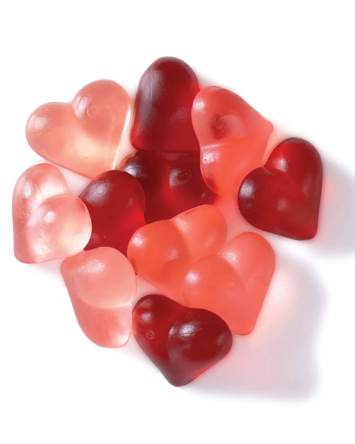 Heart-shaped red and pink gummies on a white background