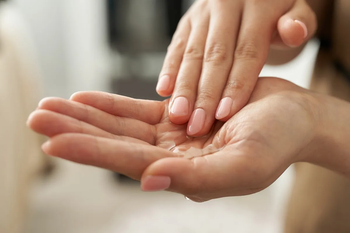 A drop of skincare product in the palm of a hand